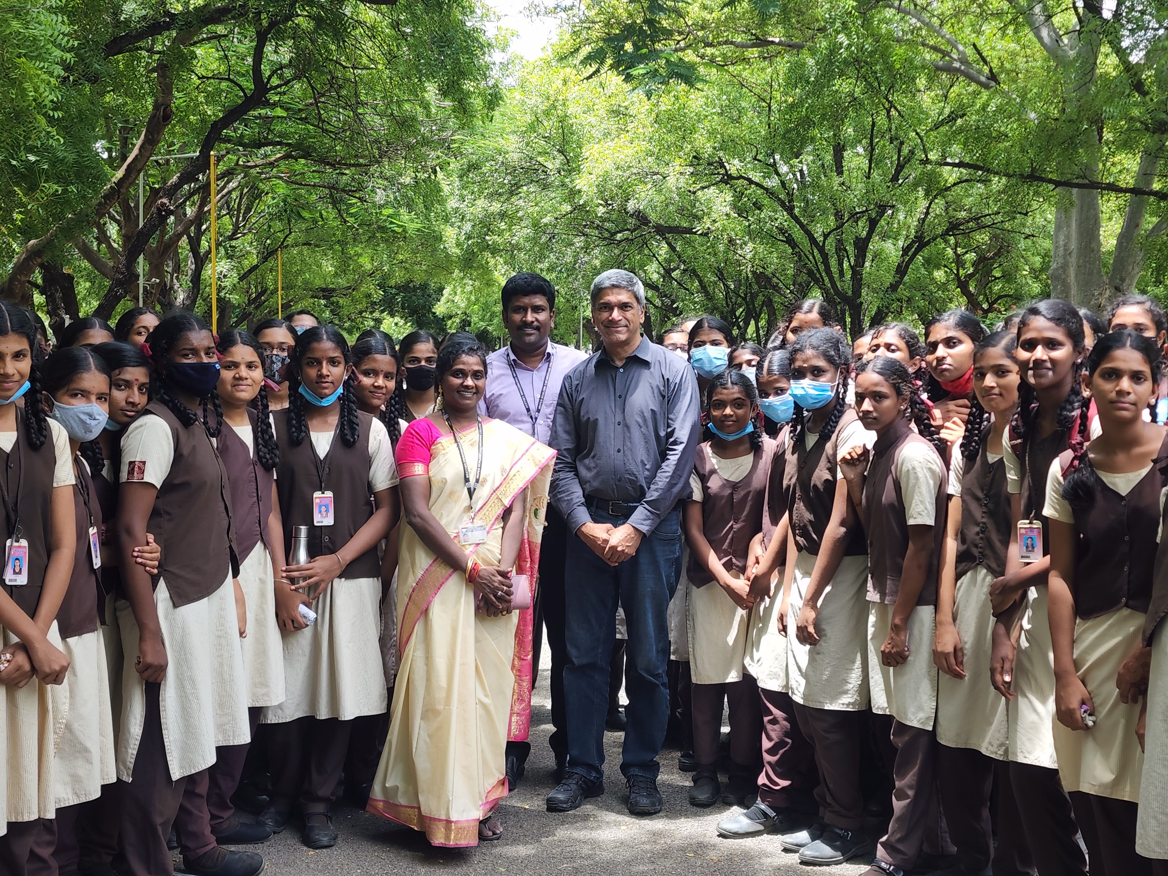 Lance with hosts, Dr. C. Gangalakshmi and Dr. L. Saranraj, along with local school students who visited the college.