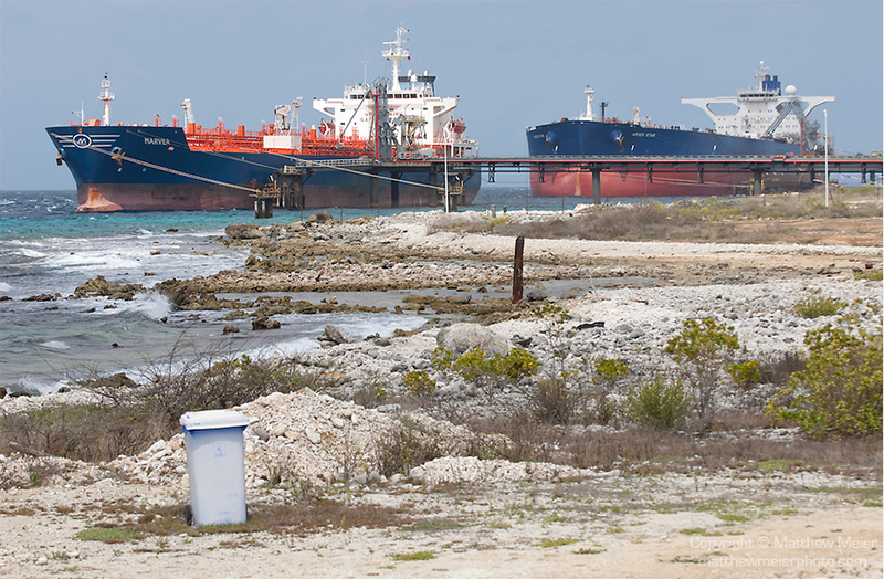 two tanker ships with shore in foreground