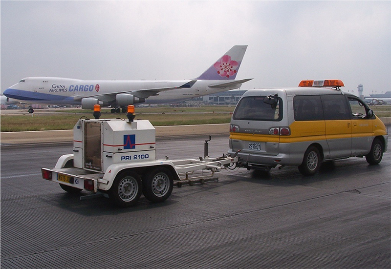 truck and plane on runway