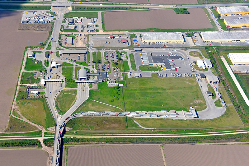 aerial view of large trucks over bridge