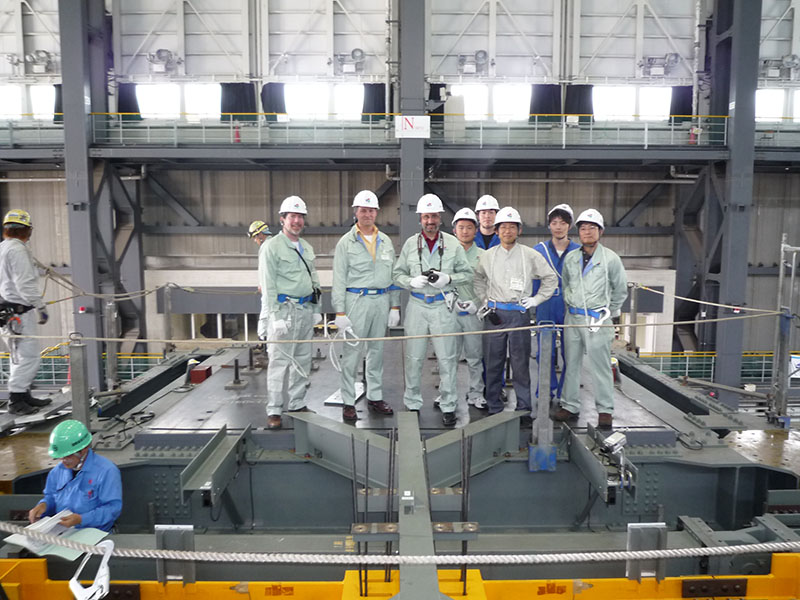 group standing on shake table in warehouse