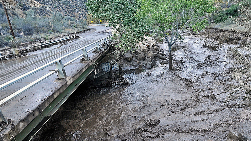 flooded river going underneath road