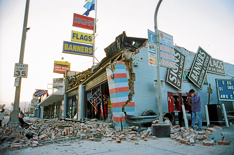 street corner with brick building collapsed from earthquake