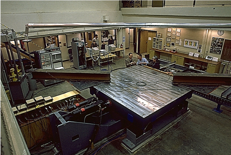 overhead view of men working in lab with steel beams