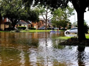 A suburban neighborhood with flood water filling the street