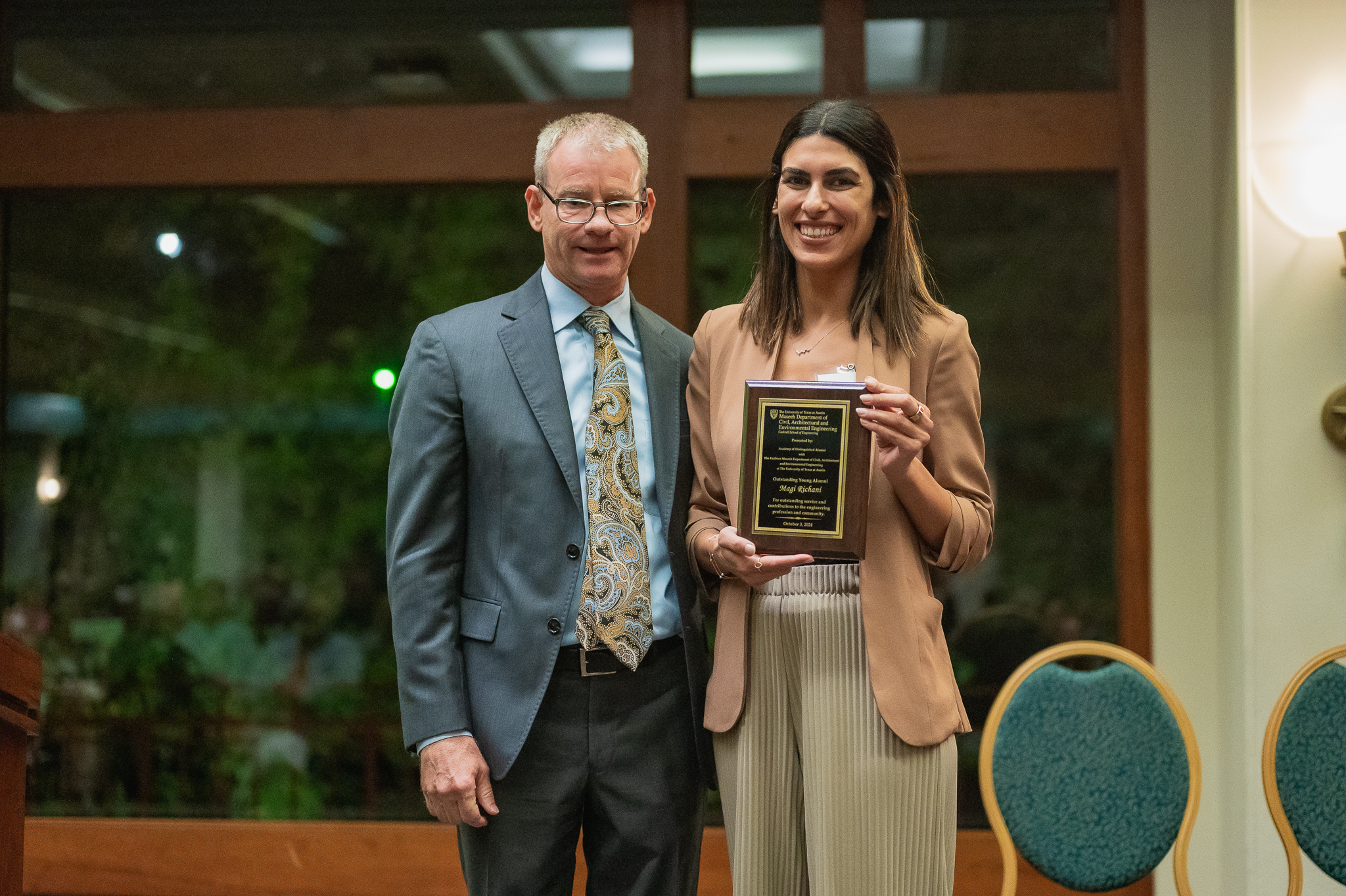 Texas CAE alumna Magi Richani holding award with CAEE department chair Bob Gilbert