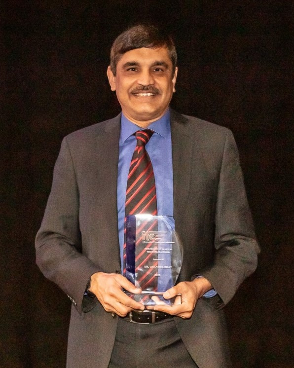 Chandra Bhat holding his 2022 Matson award